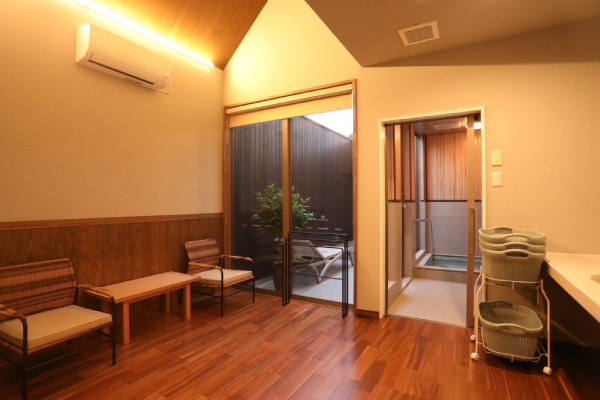 コンパクトな白タイル風呂。植栽に囲まれたプライベート空間